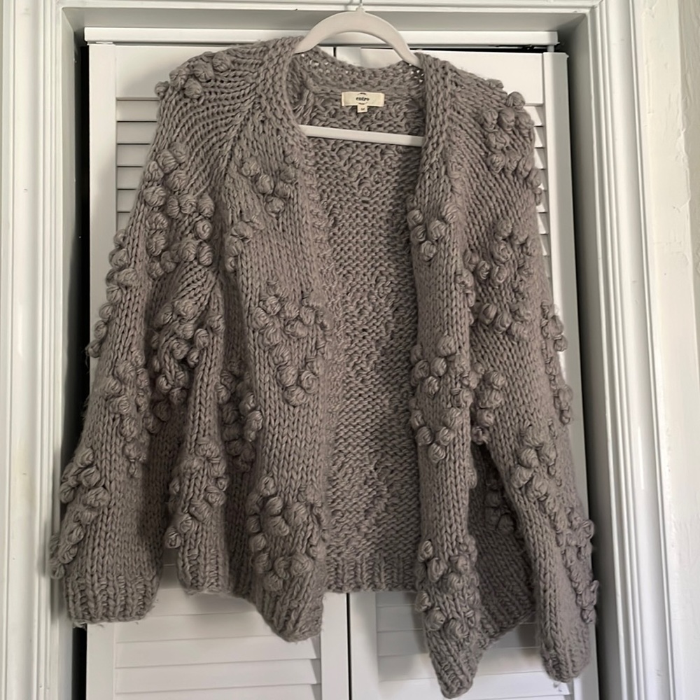 Grey knitted jacket.